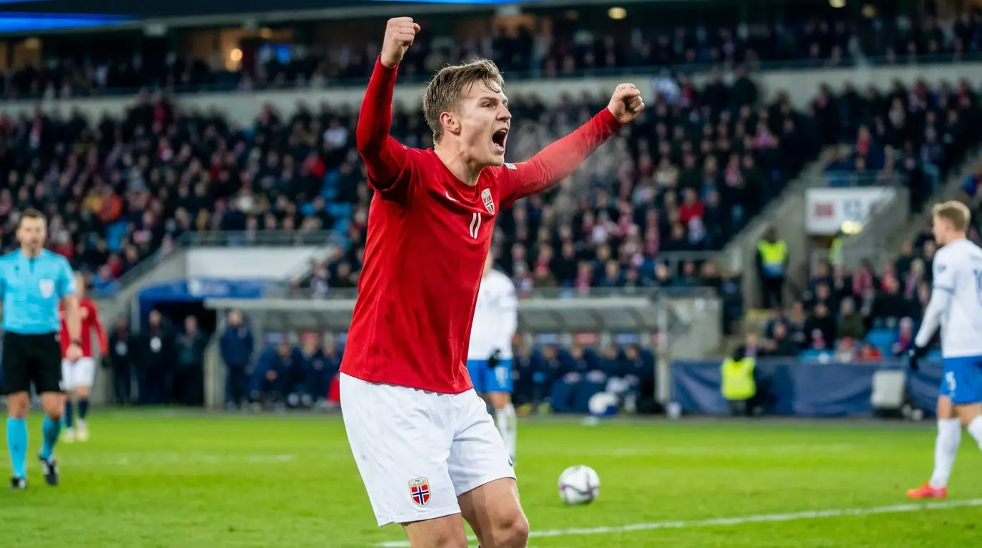 Norjan maajoukkueen pelaaja punaisessa paidassa juhlii maalia MM-karsintaottelussa
